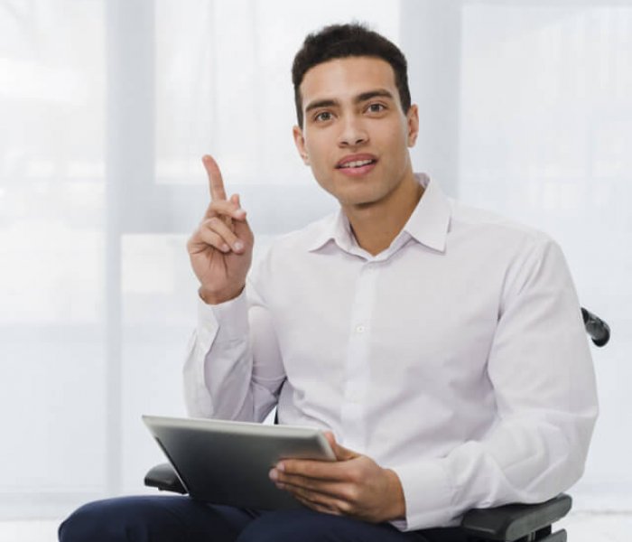 optimize-portrait-young-businessman-sitting-wheelchair-holding-digital-tablet-hand-pointing-his-finger-upward.jpg